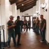 Group of men with guns in a hallway of a building