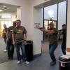 Group of men with guns in a hallway of a building